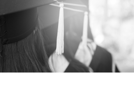 picture of 2 people in cap and gowns walking