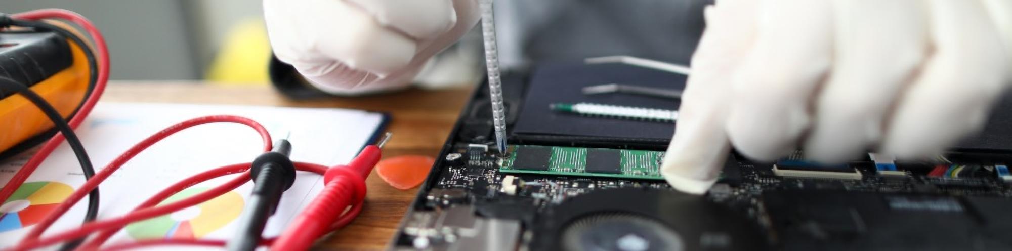 Image of a laptop being fixed