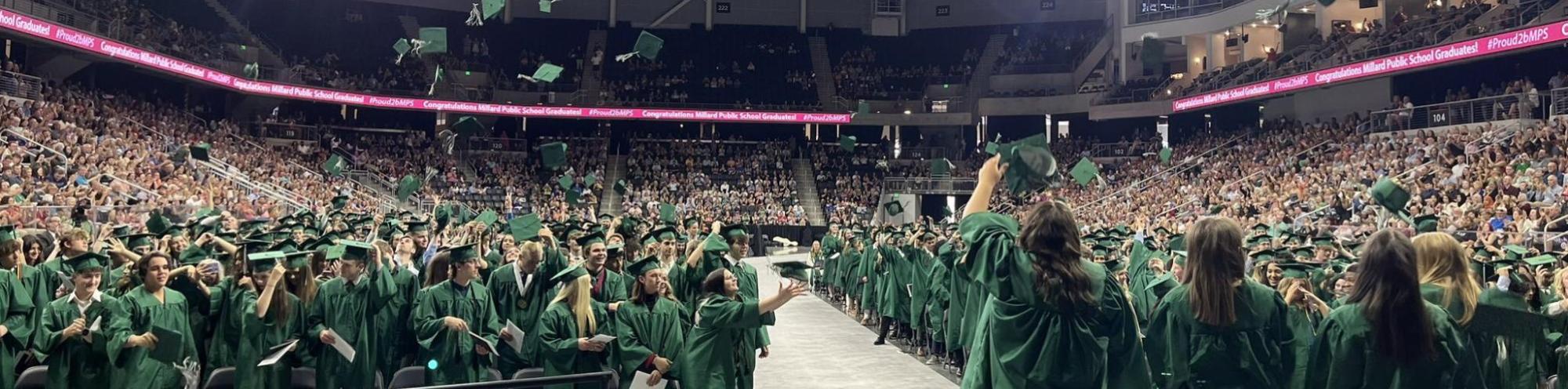 Graduates in green caps and gowns 