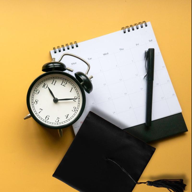 Image of a calendar, a clock and a grad cap on a yellow background