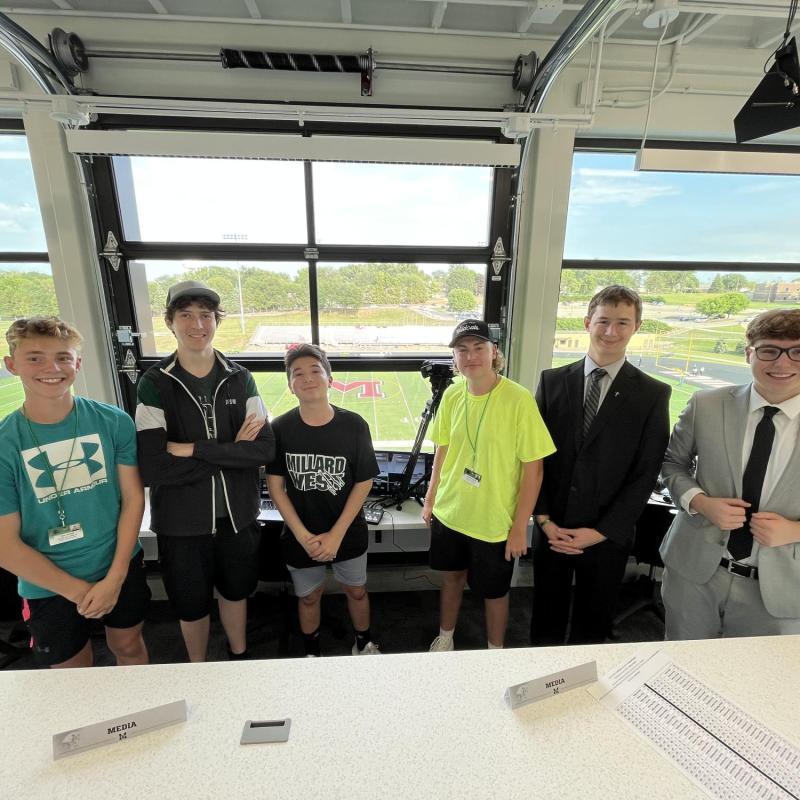 Image of 6 student journalists in the press box